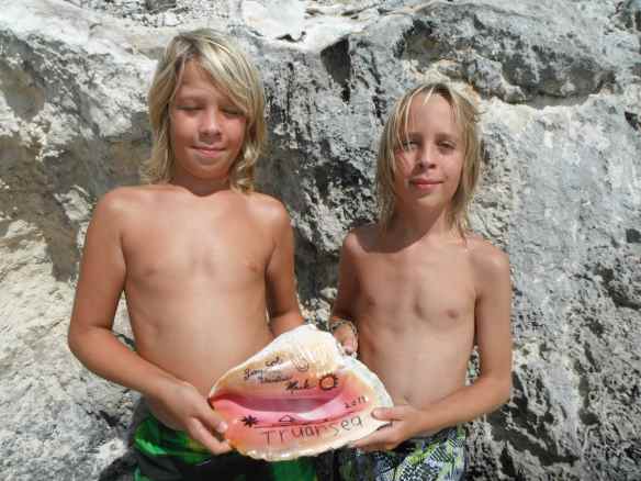Logan & Cole with conch horn they personalized to leave at Red Shanks Yacht & Tennis Club.