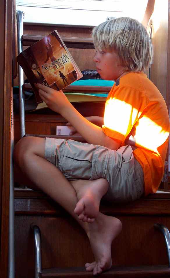 Logan hanging out reading a book his friend Max sent him.